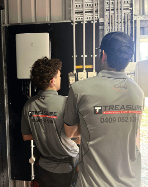 electrician and supervisor looking over solar units