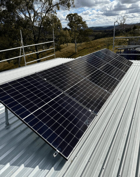 solar panels titled upright on metal roof